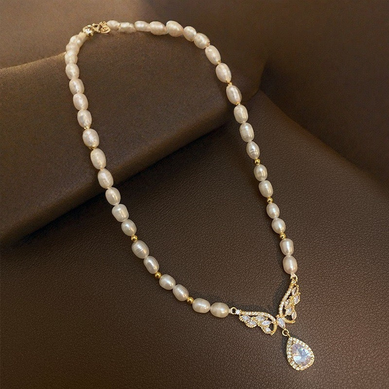 Elegant Baroque Pearl & Cubic Zirconia Winged Statement Necklace – Gold-Tone Bridal Jewelry