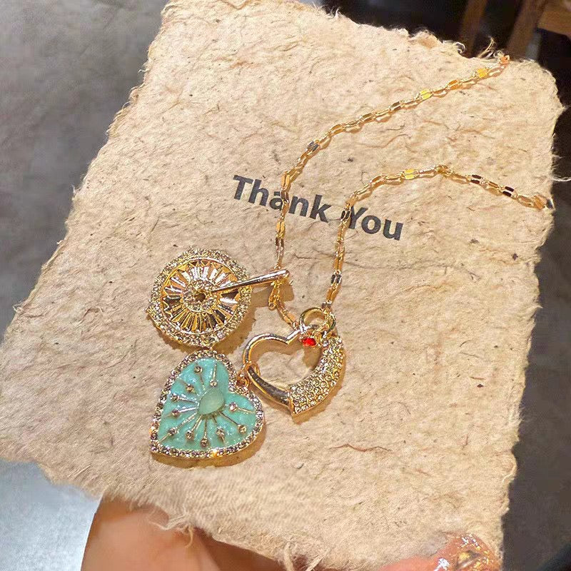 Exquisite Multi-Charm Gold Necklace – Turquoise Heart, Crystal Disk, & Pavé Heart Clasp