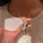 Vintage-Inspired Marquise Blue Topaz and Diamond Halo Pendant Necklace